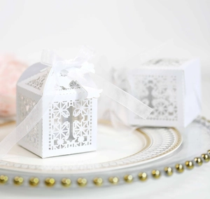 European hollow white laser-cut favor boxes with cross patterns and white satin ribbons