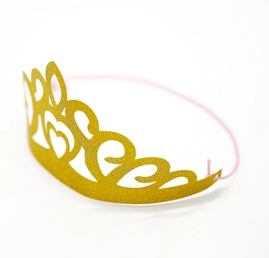 Golden glitter paper crown with laser-cut heart patterns and pink elastic strap