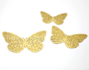 Close-up of 3D gold butterfly wall stickers with intricate laser-cut hollow patterns