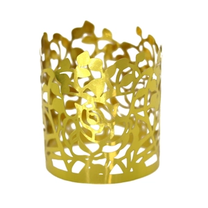 Detailed view of golden laser-cut napkin ring with reflective rose floral pattern