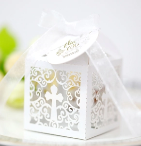 Elegant laser-cut white favor box with cross pattern, satin ribbon and thank you tag