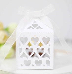 Detailed view of white laser-cut hollow heart gift box with elegant white ribbon bow