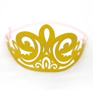 Close-up of golden glitter laser-cut party crown with pink elastic band and hollow pattern