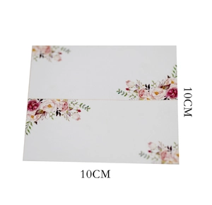 Detailed view of 10x10cm folded white table card with floral watercolor rose corners