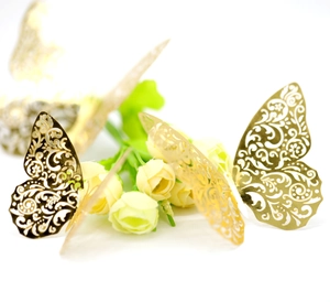 Macro view of 3D hollow laser-cut golden butterfly wall stickers for party decor