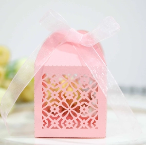 Pink laser-cut candy box with floral patterns and an elegant organza ribbon bow
