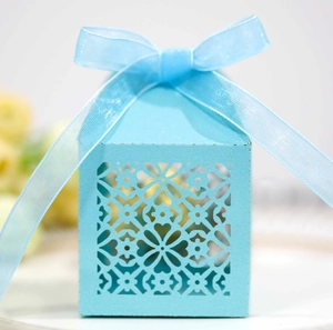 Laser-cut light blue candy gift box with floral heart pattern and blue ribbon bow