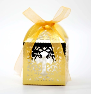 Elegant gold hollow laser cut wedding candy gift box with a sheer ribbon bow decoration