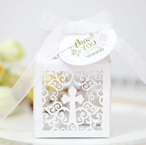 Laser-cut white wedding favor box with cross pattern, ribbon, and Thank You tag