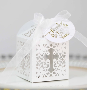 Elegant white laser-cut wedding candy box with hollow cross design and thank you tag