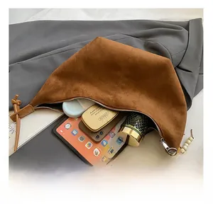 Interior view showing the large capacity of the brown suede crescent shoulder bag