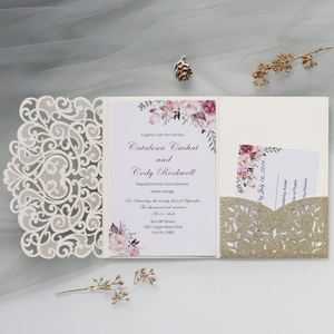 Detailed laser cut floral wedding invitation set with cream lace and gold glitter accents