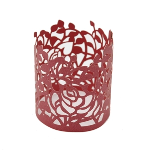 Detail of red laser-cut paper napkin ring featuring an intricate rose floral pattern