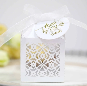 Elegant white laser-cut floral candy box with silk ribbon and thank you tag for weddings