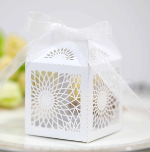 Macro detail of laser-cut sunflower pattern on white cardstock wedding favor box