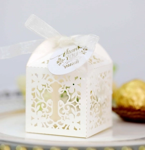 White laser cut cross gift box for weddings with white organza ribbon and thank you tag