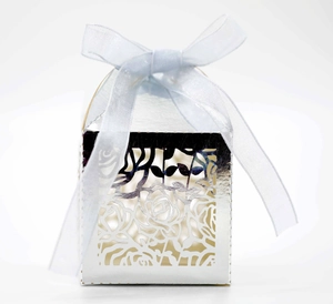 Detail of silver hollow rose wedding candy box with light blue ribbon and bow