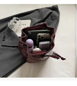 Interior view of burgundy leather bucket bag showing storage space for tablet and phone