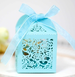 Light blue hollow laser-cut wedding favor box with rose patterns and matching ribbon