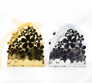 Laser cut hollow flower wedding candy boxes in gold and silver with ribbon bows