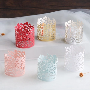 Macro detail of laser-cut paper napkin rings with intricate rose and leaf patterns