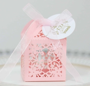 Pink laser-cut wedding favor box with ribbon bow and gold Thank You tag detail