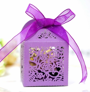 Elegant purple laser-cut wedding favor box with rose patterns and ribbon tie