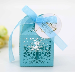 Detail of light blue laser-cut candy box with floral patterns and a Thank You tag