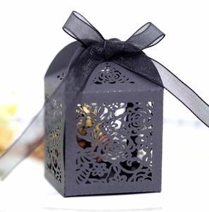 Detailed laser-cut rose patterns on elegant black wedding favor box with a chiffon ribbon