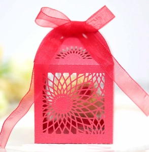 Detailed macro view of laser-cut sunflower pattern on a red paper hollow gift box