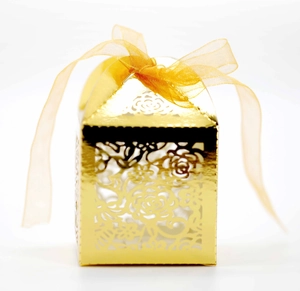 Elegant gold laser-cut favor box with rose patterns and ribbon for wedding parties