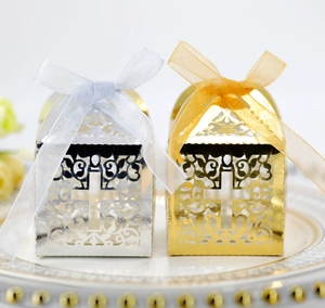 Detail showing silver and champagne gold hollow gift boxes with cross and organza ribbon