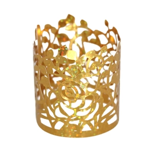 Detail of laser-cut gold paper napkin ring featuring a hollow rose flower pattern