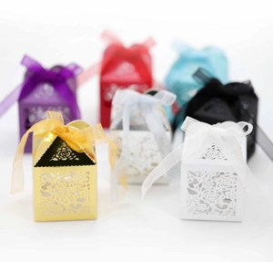 Detailed laser-cut rose hollow favor boxes with ribbon bows in multiple colors