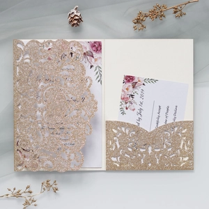 Detailed champagne gold laser-cut lace wedding invitation with floral insert card