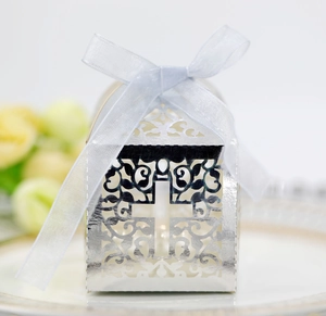 Detailed view of silver hollow gift box with cross pattern and blue organza ribbon