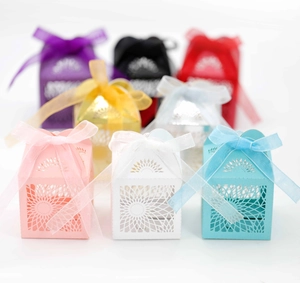 Close-up of laser-cut sunflower hollow candy boxes with matching organza ribbons