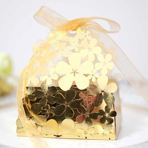 Elegant gold laser-cut hollow floral gift box with silk ribbon for wedding and party favors