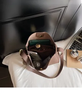 Detailed interior view of a brown pebbled leather bucket bag showing large storage capacity