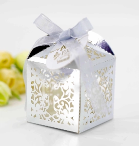 Laser-cut silver wedding candy box with floral patterns, blue ribbon, and thank you tag
