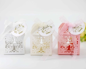 Detail of laser-cut floral candy boxes in white and pink with Thank You tags