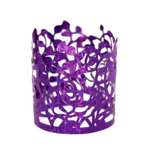 Close-up of laser-cut purple glitter cupcake wrapper with rose flower patterns