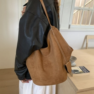 Brown frosted leather tote bag shown on model for daily commuting or student use