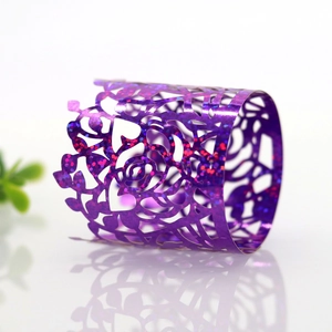Detail of purple glitter laser-cut paper napkin ring with intricate rose floral patterns