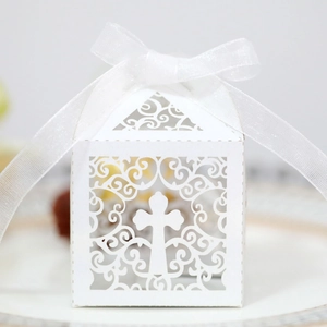 Elegant white laser-cut wedding favor box with cross pattern and white ribbon bow