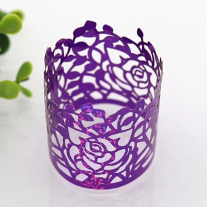 Detailed close-up of a purple glitter laser-cut paper napkin ring with a rose pattern