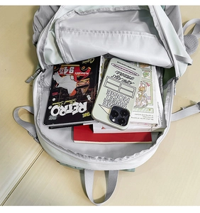 Top view showing the spacious interior compartments of the green travel backpack