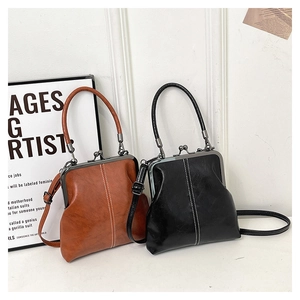 Detail view of vintage shell crossbody bags in black and brown with metal clasp closure