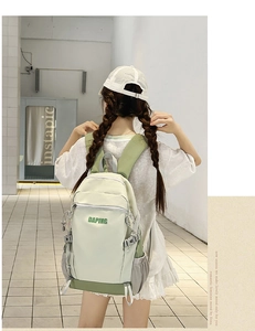 Detail of light green canvas backpack with DAPING logo showing side pockets and straps