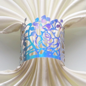 Detailed laser-cut rose napkin ring with a shimmering holographic finish for festive tables